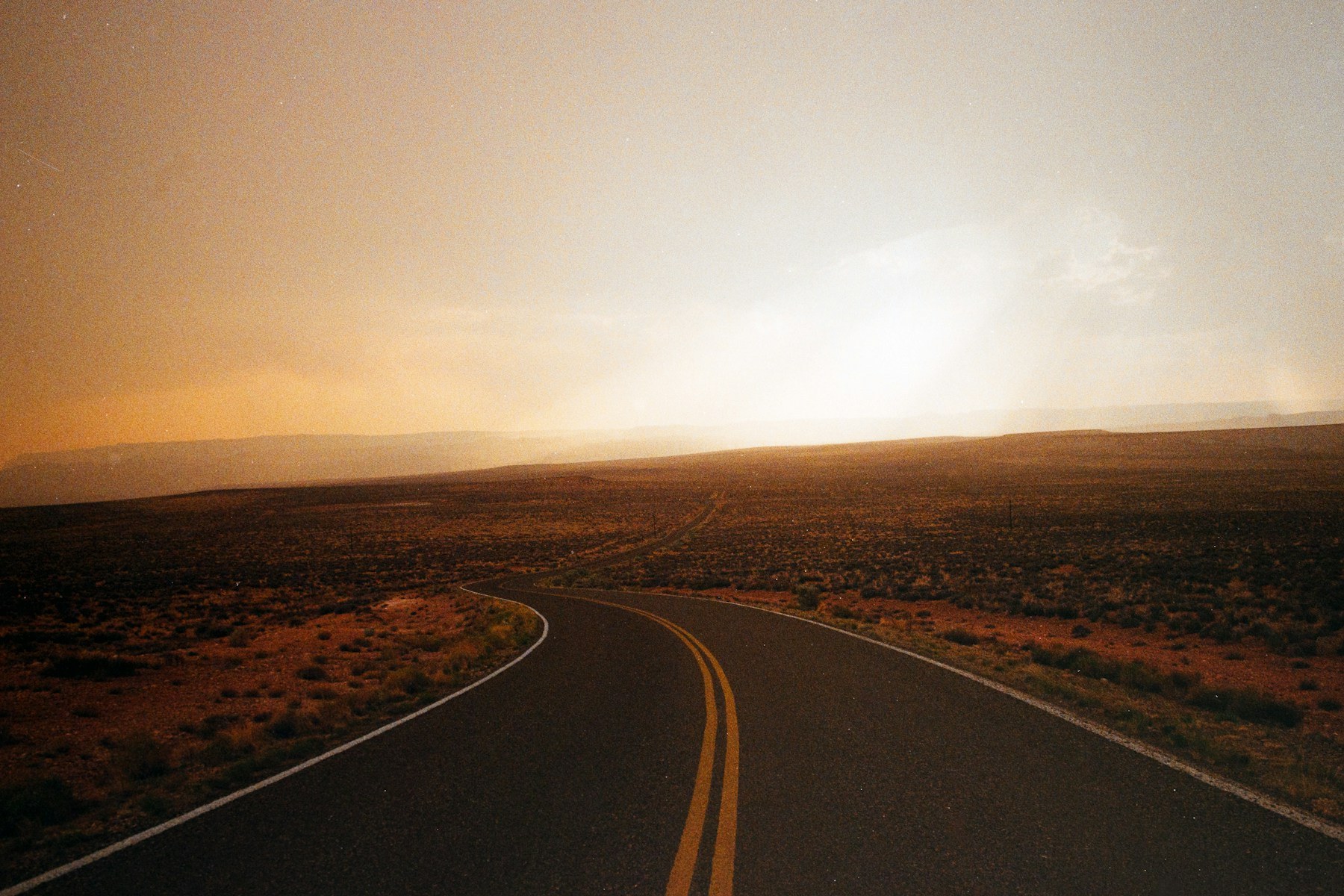 An open desert road in Arizona at sunset